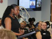 woman speaks at podium