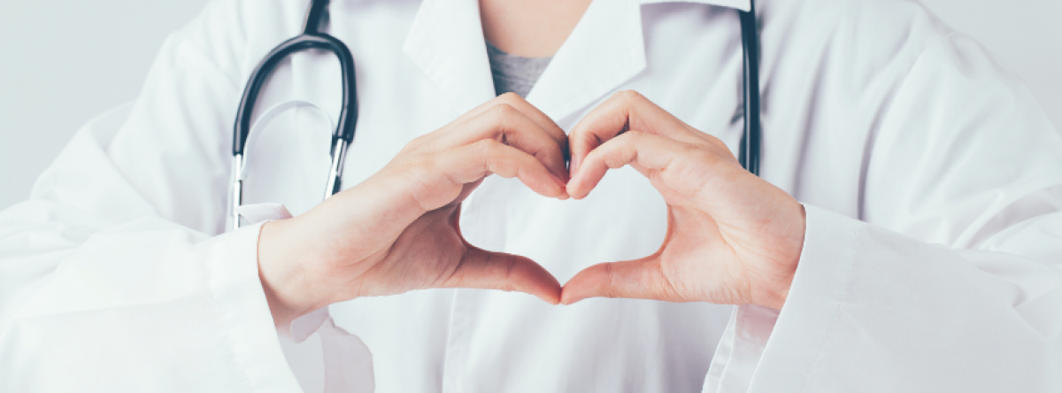 closeup of doctor's hands making a heart